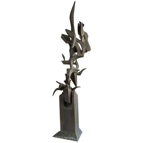 Tall abstract steel sculpture composed of twisting, flame-like vertical forms rising from a rectangular base.