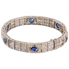 Art Deco platinum bracelet set with calibre-cut sapphires and square diamond panels.