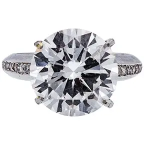 Platinum ring set with 9.10 carat round brilliant diamond and pavé diamond shoulders.