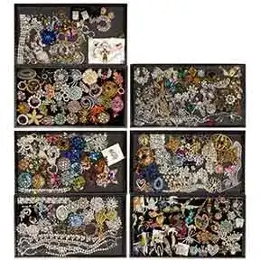 Additional assortment of vintage rhinestone and costume jewelry including pins, chains, and statement pieces.