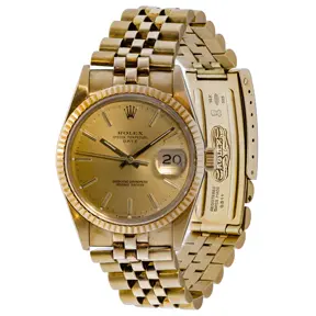 Rolex 14k yellow gold Oyster Perpetual Date wristwatch with fluted bezel and Jubilee bracelet.