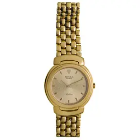 Rolex Cellini 18k yellow gold wristwatch with minimalist round dial and brick-link bracelet.